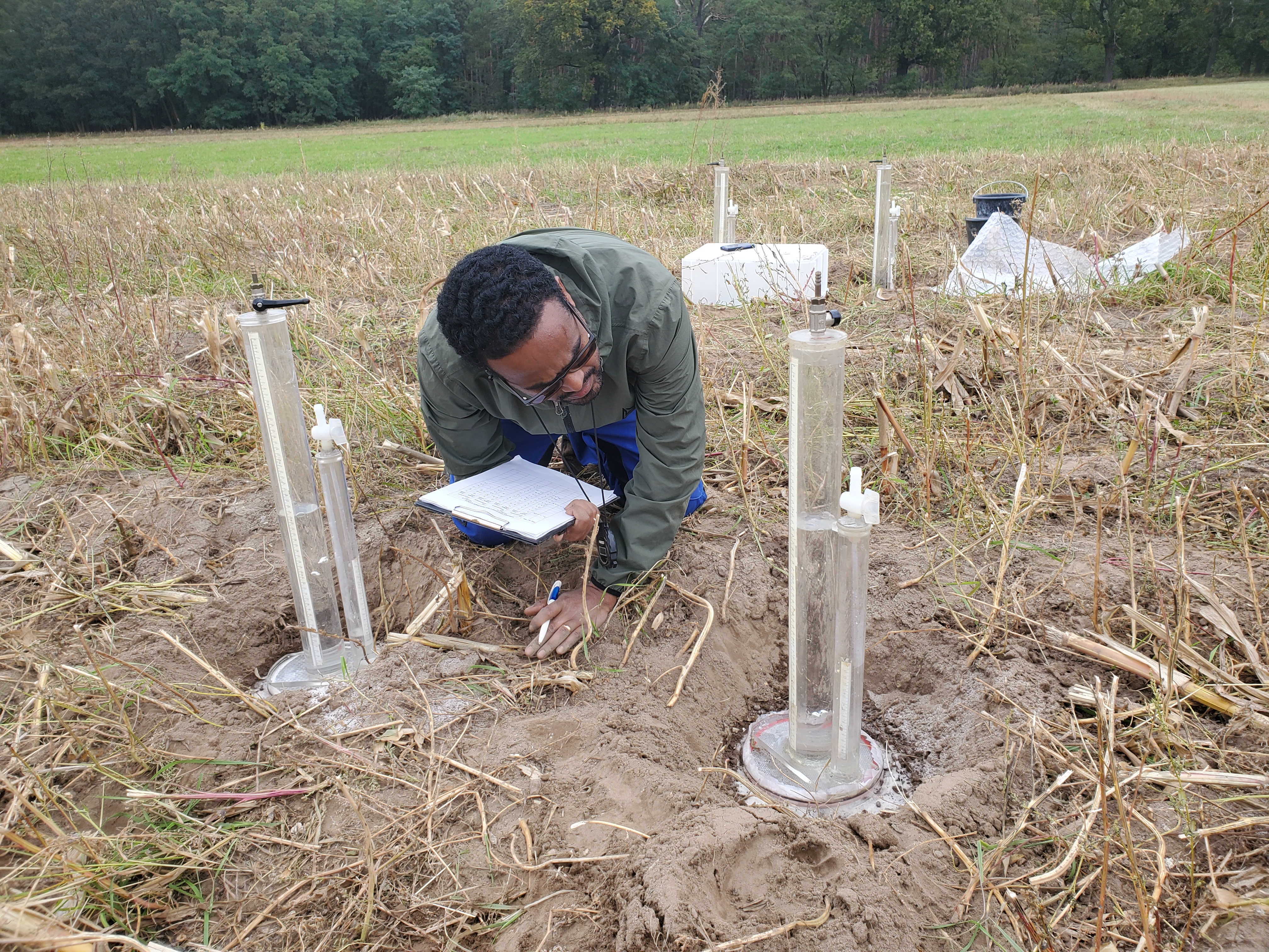 A man studying experiments in a field